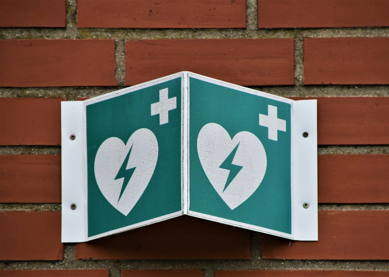Logo défibrillateur sur mur de briques