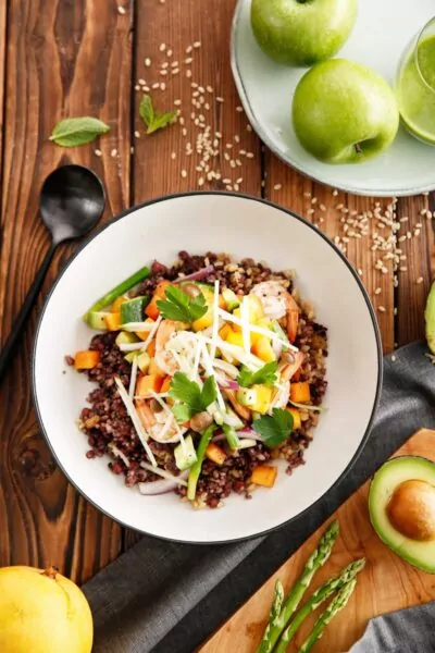 a white bowl filled with rice and vegetables