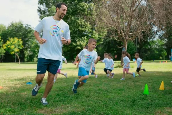 a group of people running around a field