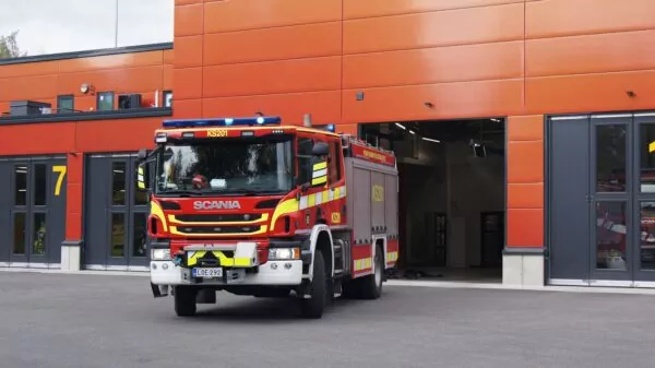 a fire truck parked in front of an orange building